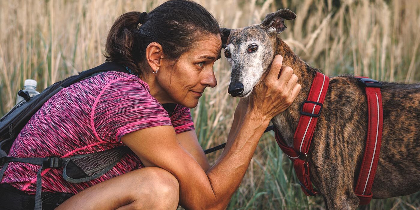 Hispanic Woman Walking Her Old Dog