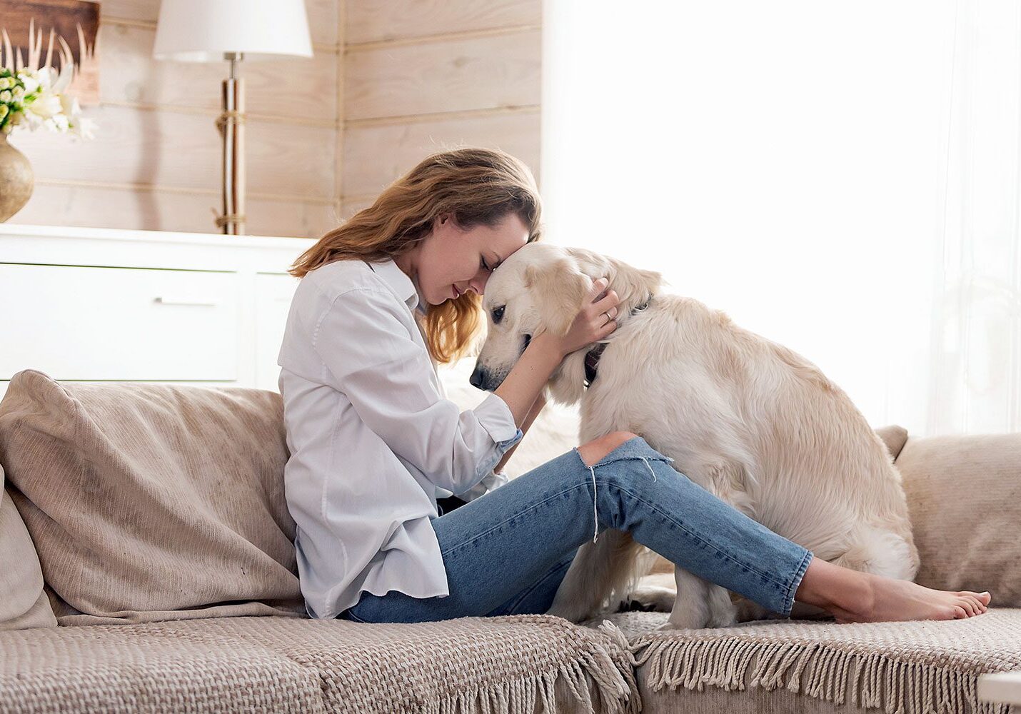 woman on couch with her old dog